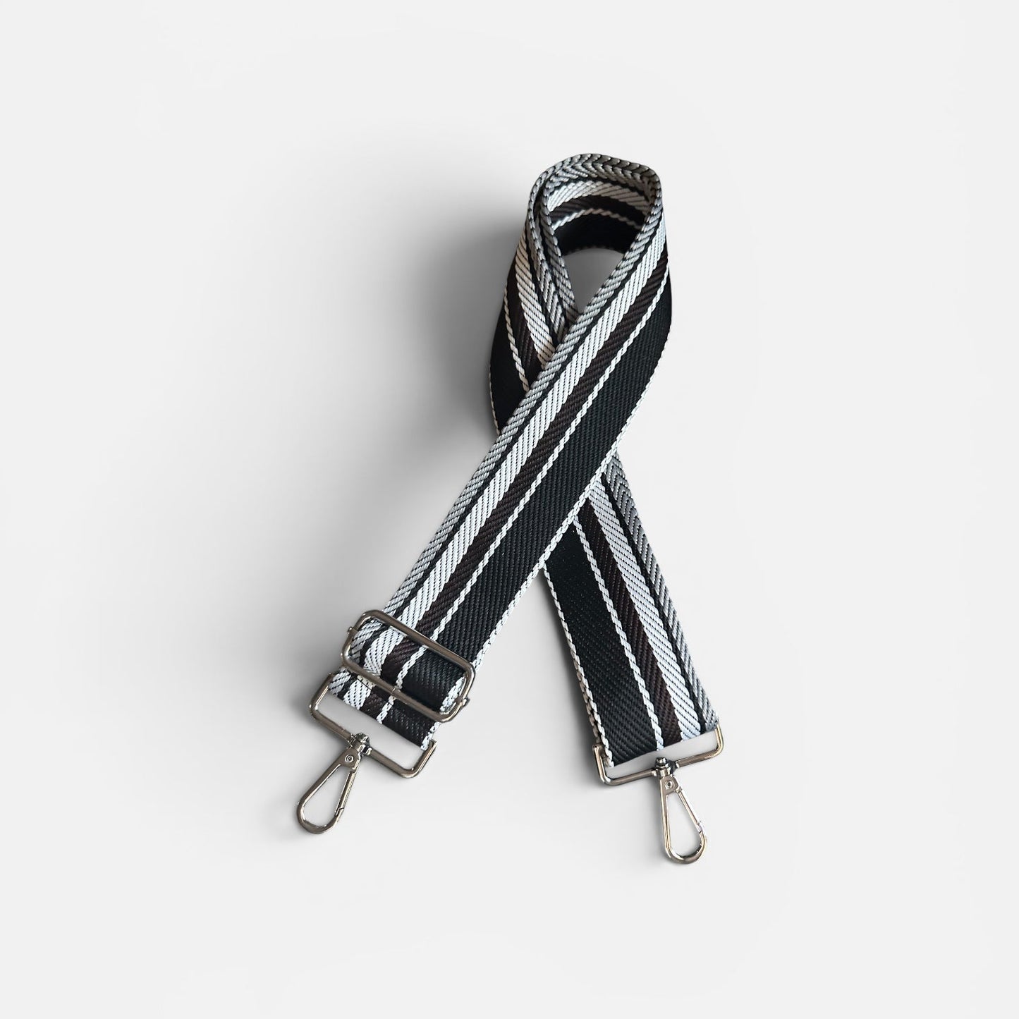 Black and white striped bag strap on a light gray background