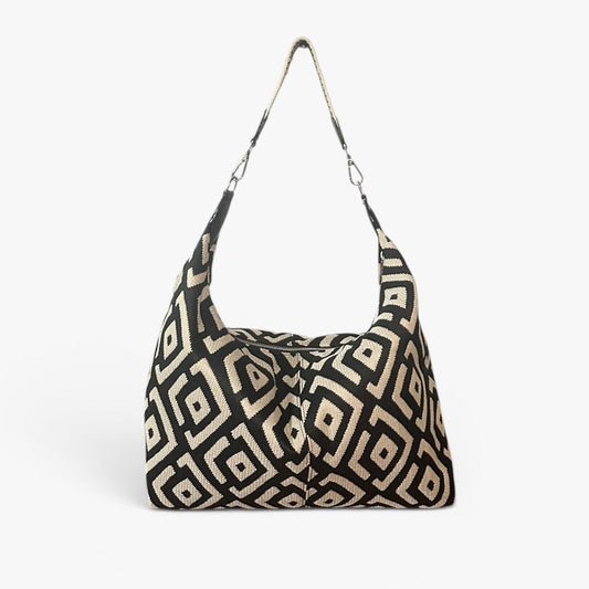 Black and cream large shoulder bag featuring a modern geometric design, spacious silhouette, and artisan-inspired details for everyday wear.
