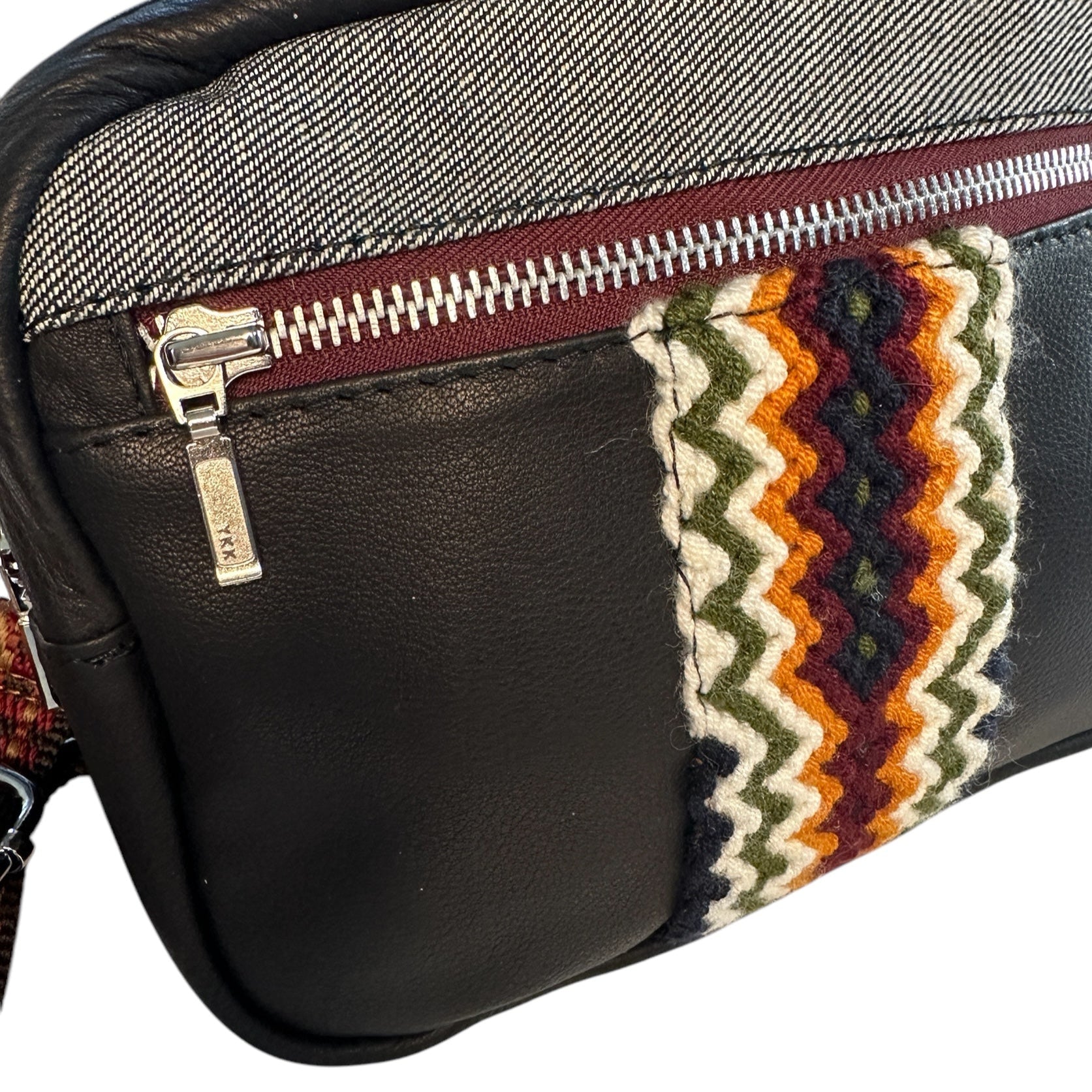 Black leather multi colored crossbody sling bag.