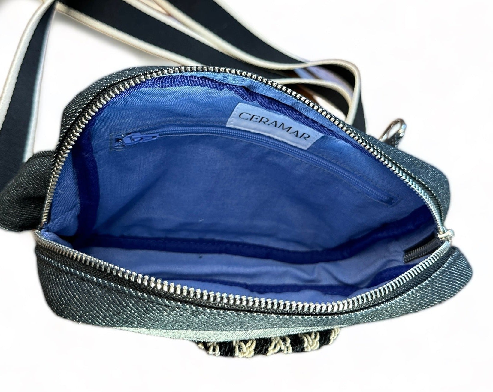 Black denim sling crossbody travel bag.