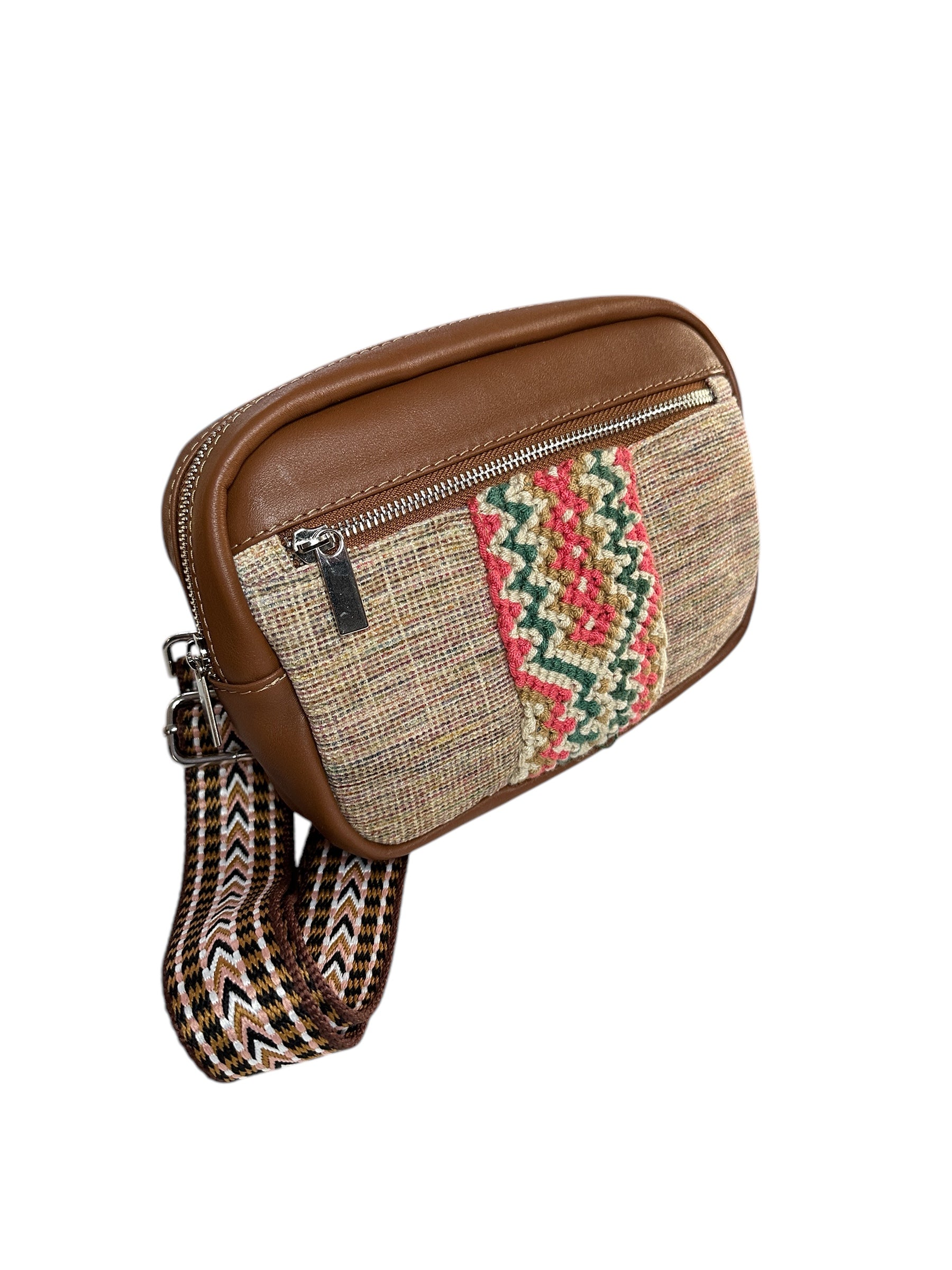 Leather and fabric sling bag with colorful web.