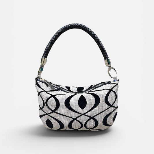 Handbag with black and cream pattern on a light gray background