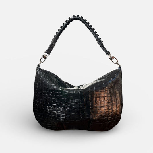 Black textured handbag on a light gray background