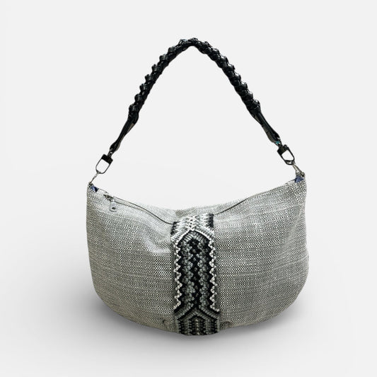 Textured handbag with a braided handle on a white background