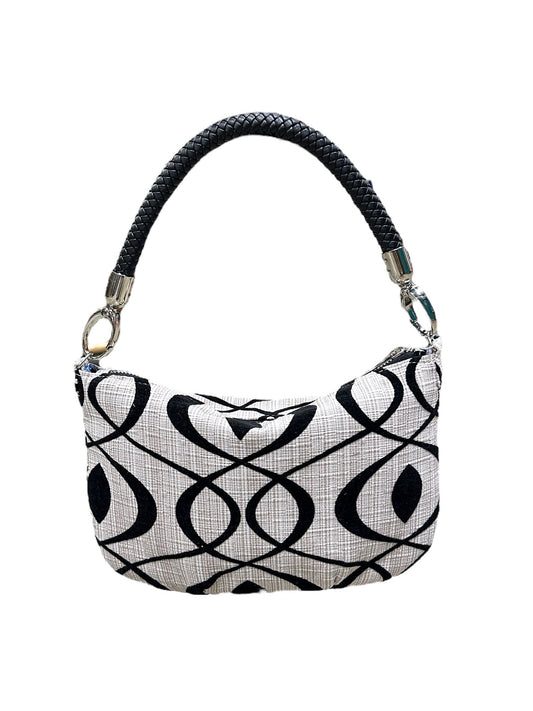 Black and white patterned handbag on a white background