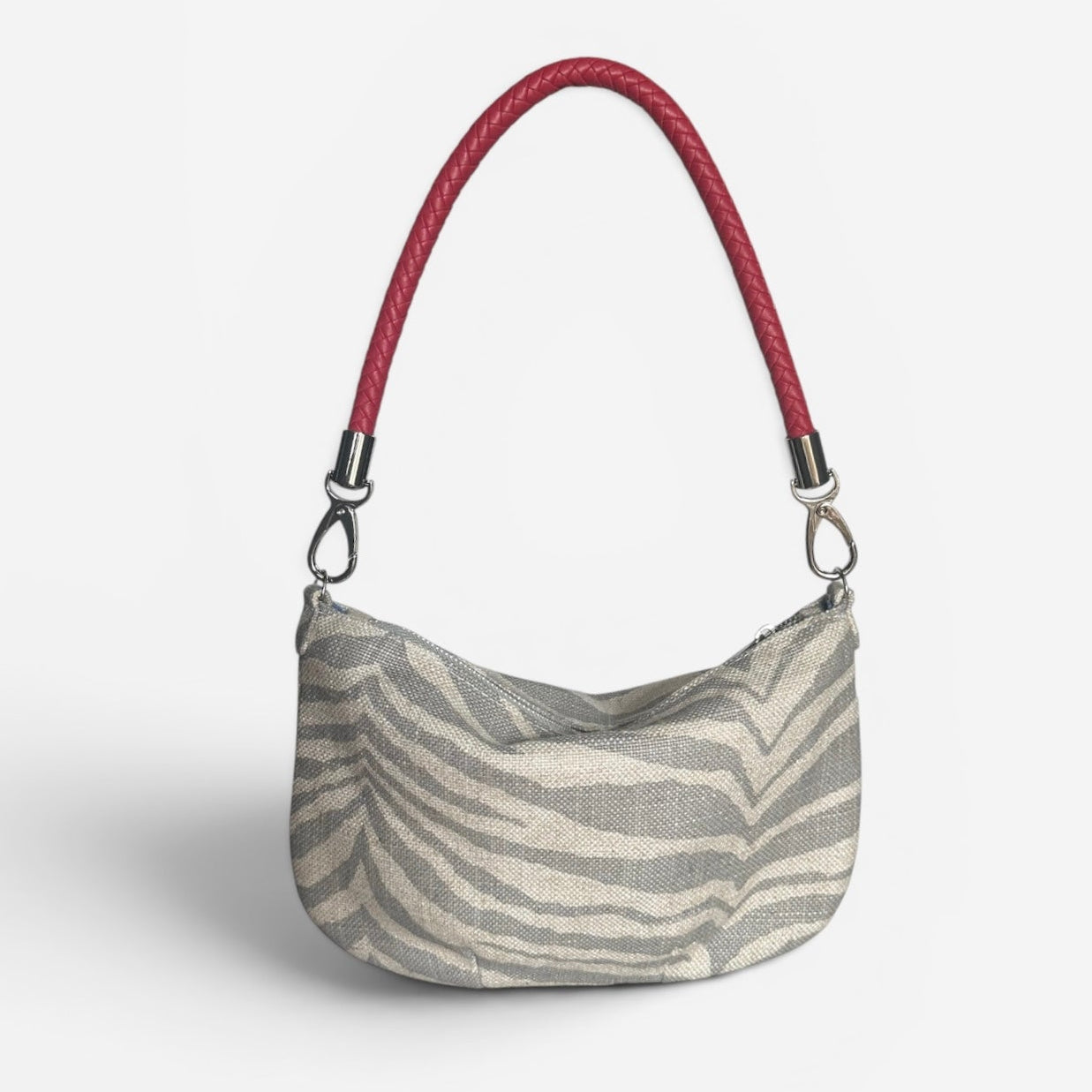 Mini zebra fabric hobo shoulder bag featuring a red braided shoulder strap, compact silhouette, and artisan-inspired.