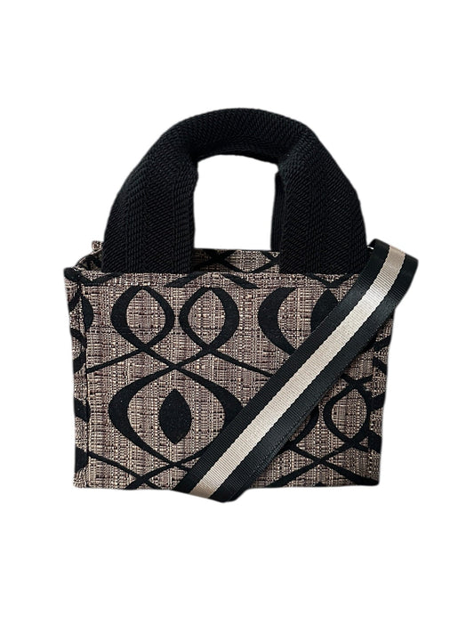 Black and beige patterned handbag with a strap on a white background