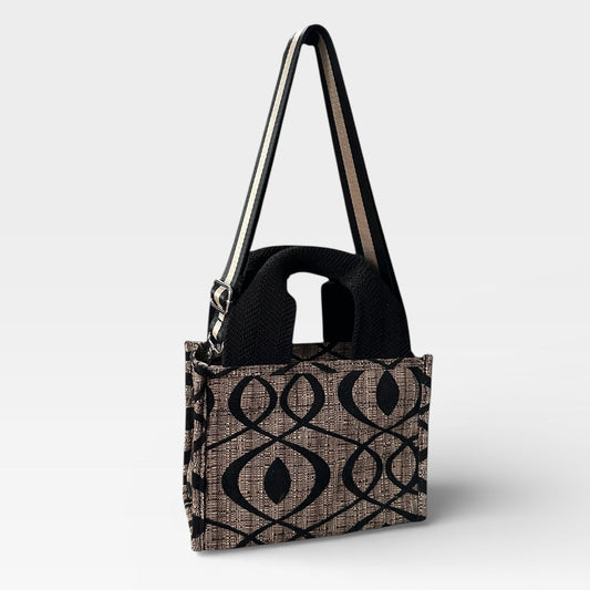 Handbag with geometric pattern on a light gray background