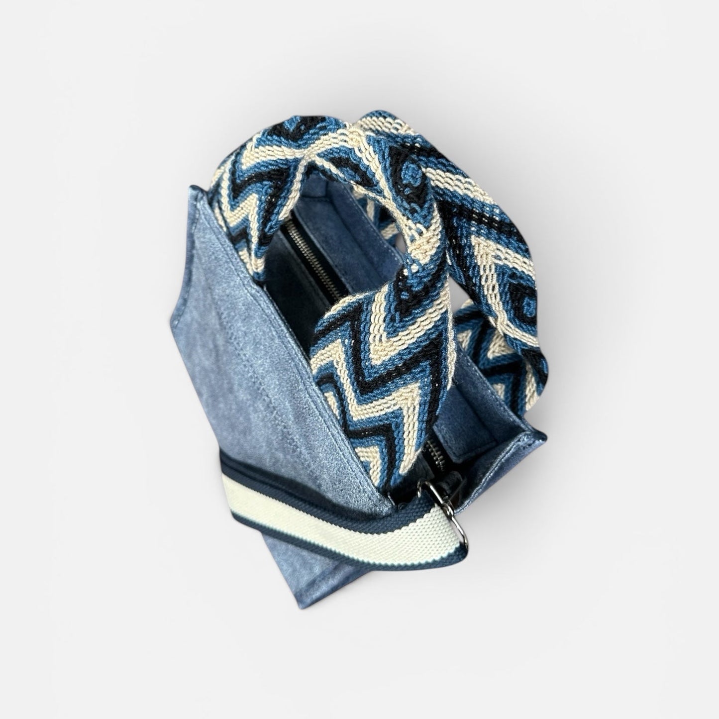 Blue and white patterned bag with a black interior on a light gray background
