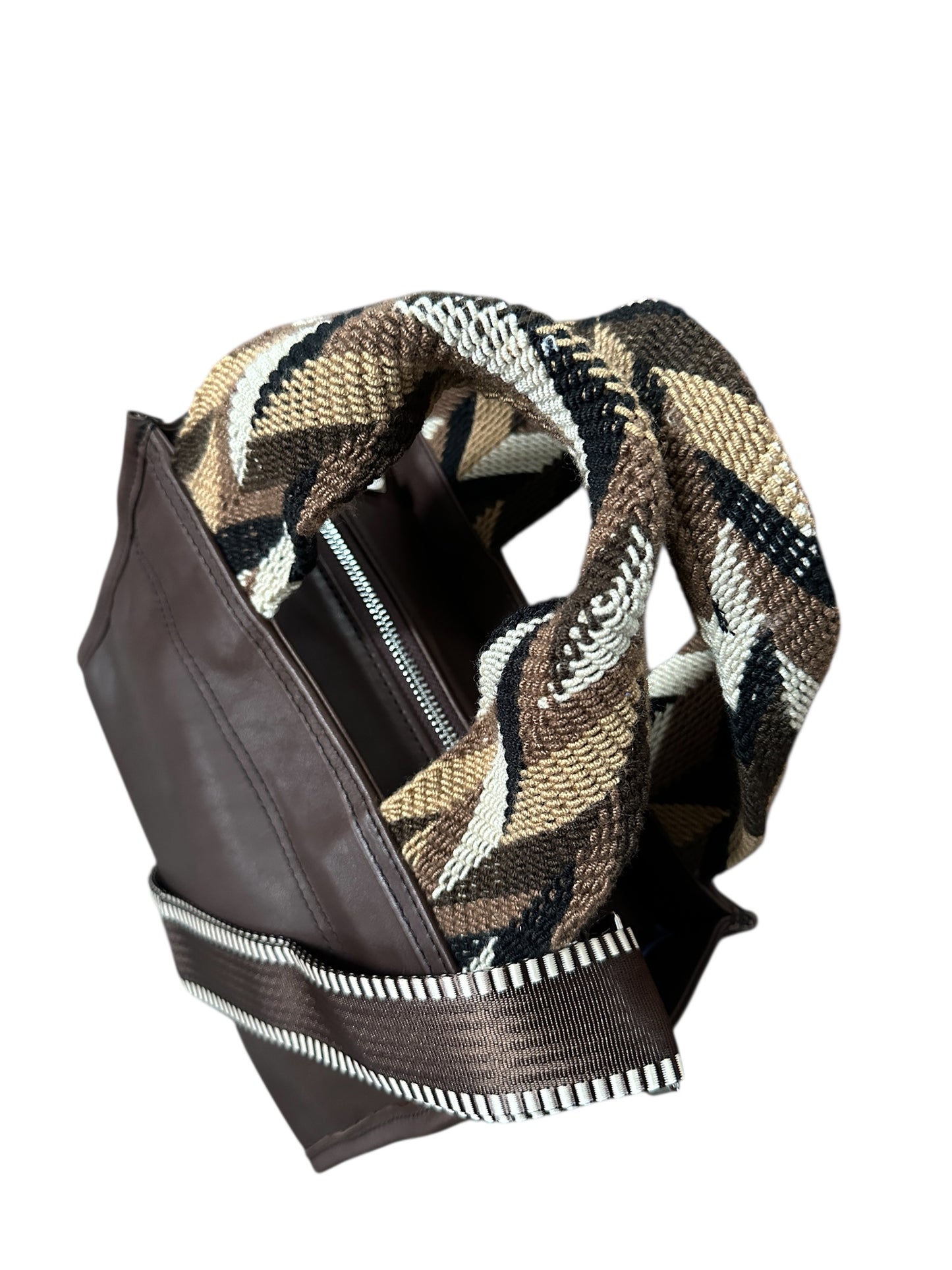 Brown leather jacket with a patterned scarf draped over it on a white background