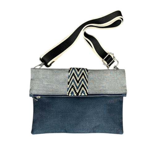 Crossbody bag with gray top section and blue bottom section on a white background