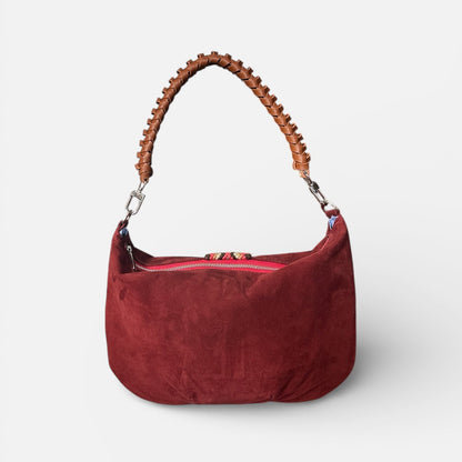 Red handbag with wooden handle on a white background