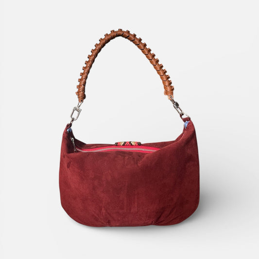 Red handbag with wooden handle on a white background