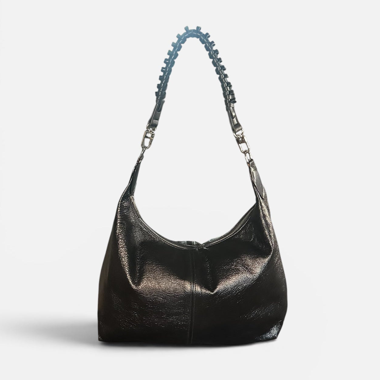 Medium black crinkle leather slouchy shoulder bag featuring a black braided leather shoulder strap, relaxed silhouette, and spacious interior for everyday style.