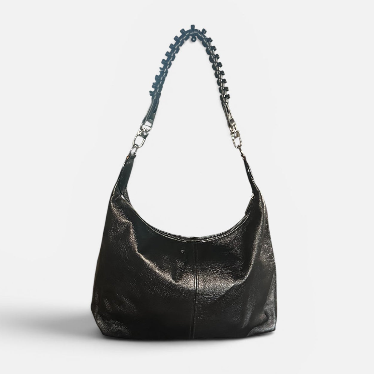 Medium black crinkle leather slouchy shoulder bag featuring a black braided leather shoulder strap, relaxed silhouette, and spacious interior for everyday style.