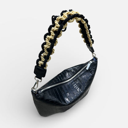Black leather waist bag with braided handle on a white background