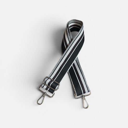 Black and white striped bag strap on a light gray background