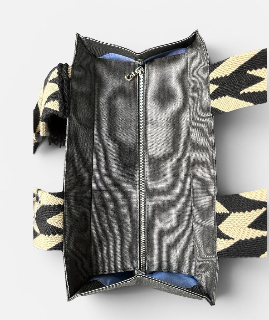 Open handbag with geometric pattern on a white background