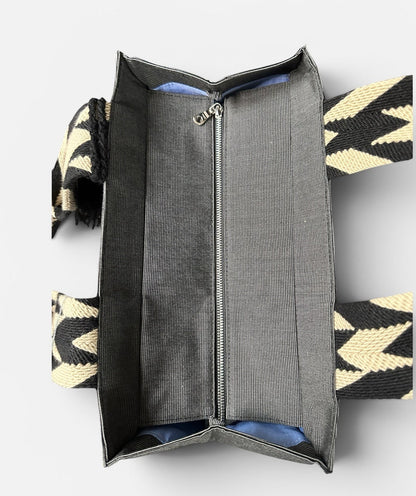 Open handbag with geometric pattern on a white background