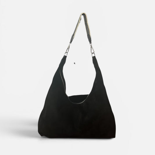Large black suede slouchy shoulder bag featuring a handwoven Wayuu strap, spacious interior, and artisan craftsmanship for work, travel, and everyday style.