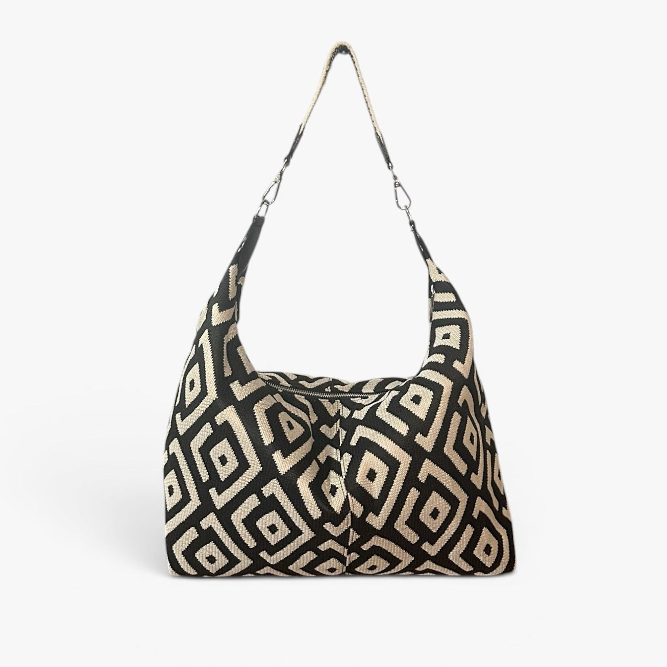 Black and cream large shoulder bag featuring a modern geometric design, spacious silhouette, and artisan-inspired details for everyday wear.