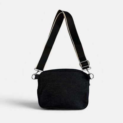 Black shoulder bag on a light gray background