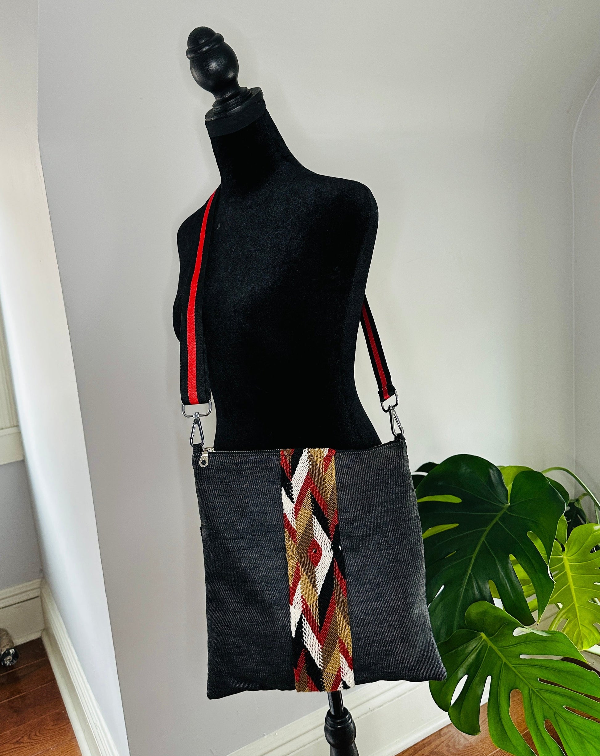 Black denim long crossbody bag with Wayuu trim. 