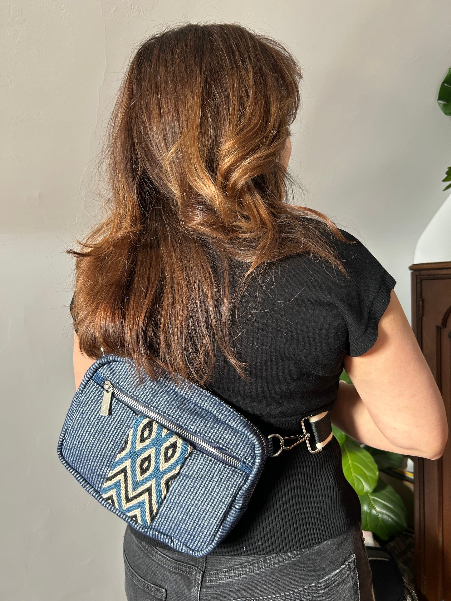 Blue stripe sling bag with colorful web. 