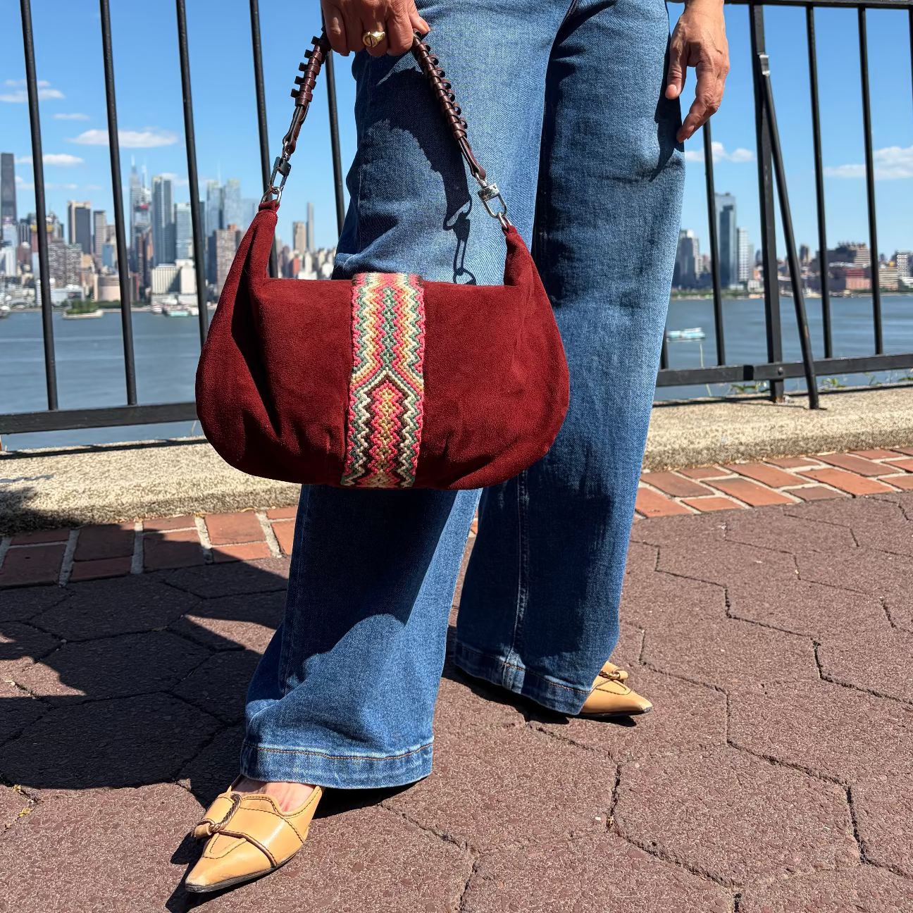 Burgundy suede hobo shoulder bag featuring a handwoven Wayuu decorative strap with leather trim, a soft slouchy silhouette, and a spacious interior for everyday use.