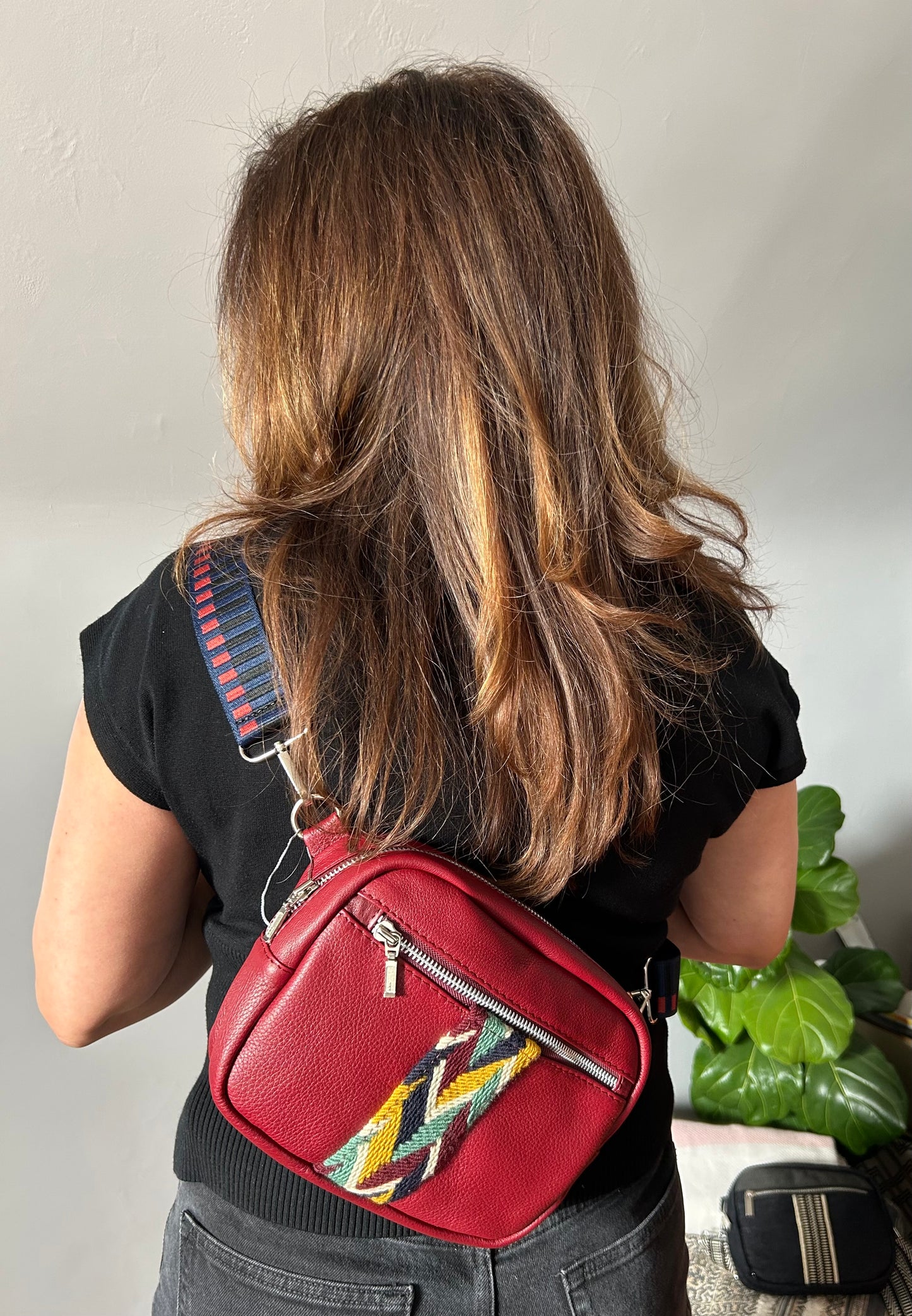 Burgundy leather multi colored crossbody sling bag.