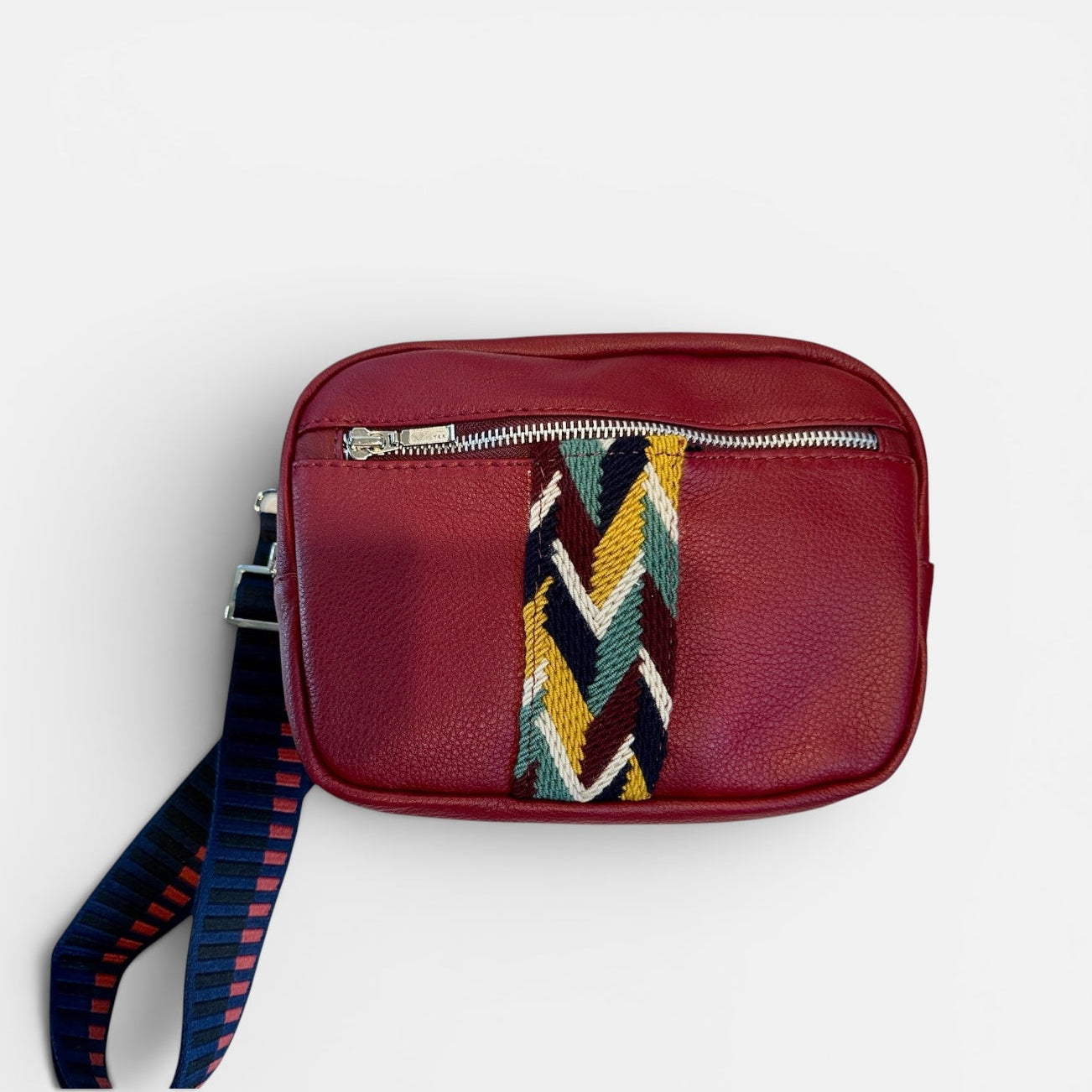 Red leather pouch with a colorful strap on a white background