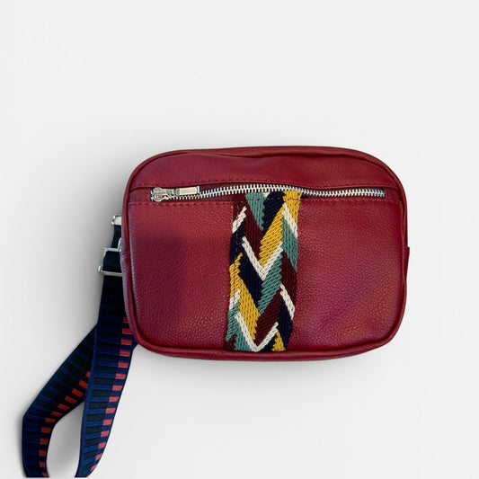 Red leather pouch with a colorful strap on a white background