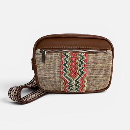 Small crossbody bag with a patterned strap on a white background