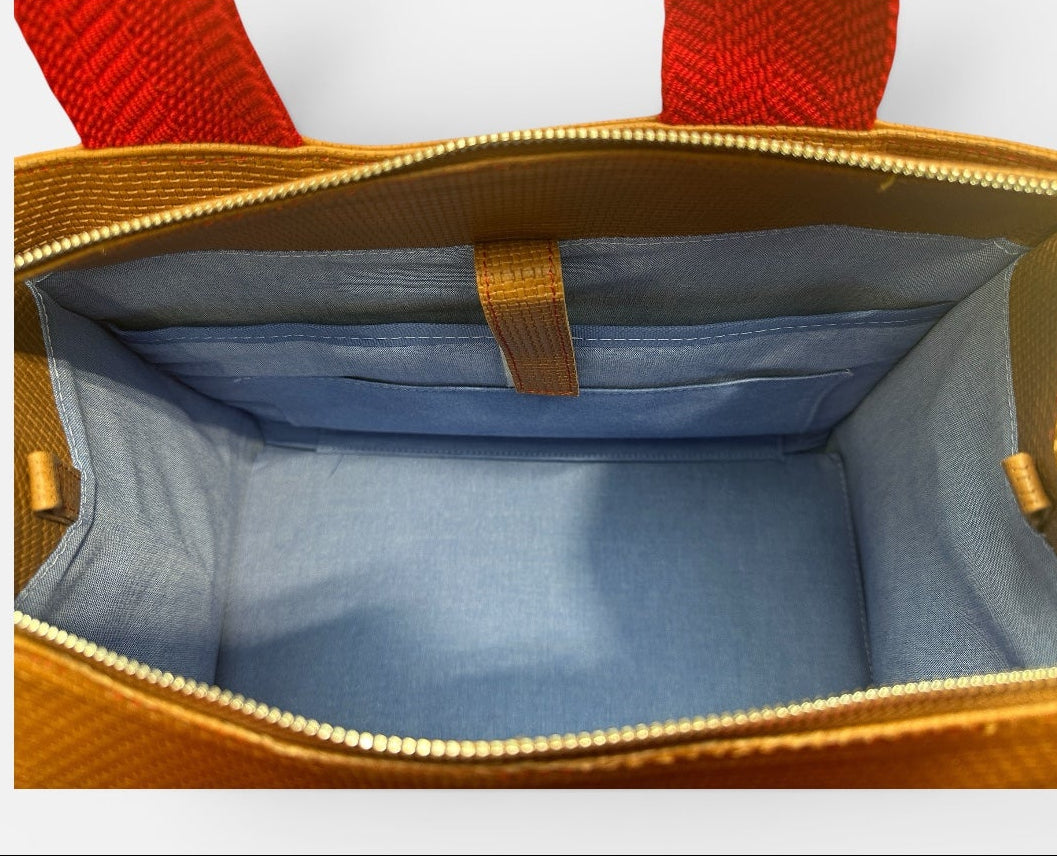 Open handbag with red handles on a white background