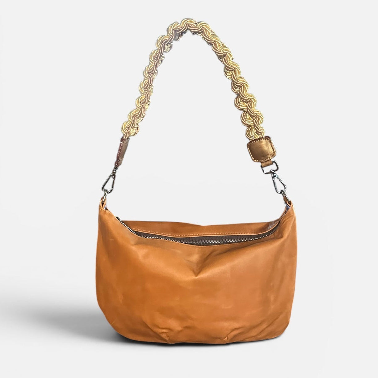 Medium caramel leather slouchy shoulder bag featuring a handwoven cord braided shoulder strap, soft silhouette, and spacious interior for everyday use.