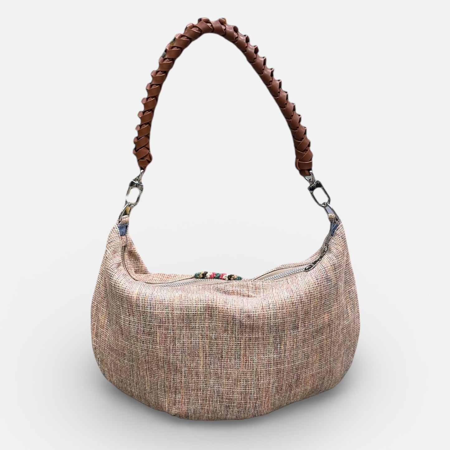 Textured handbag with braided handle on a white background
