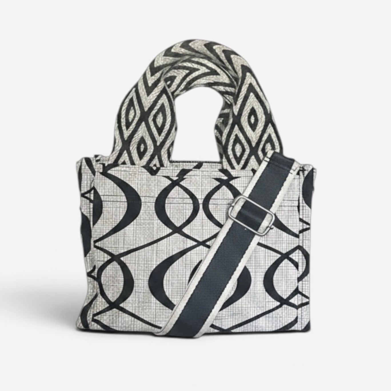 Small Jules tote in cream and black swirl fabric featuring handwoven Wayuu strap handles, a removable crossbody strap, and a structured design for everyday use.
