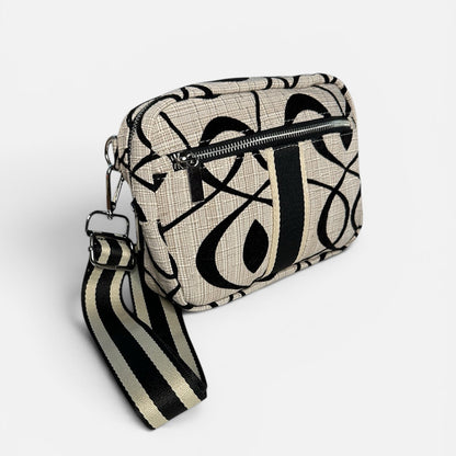 Patterned bag with a ribbon on a white background