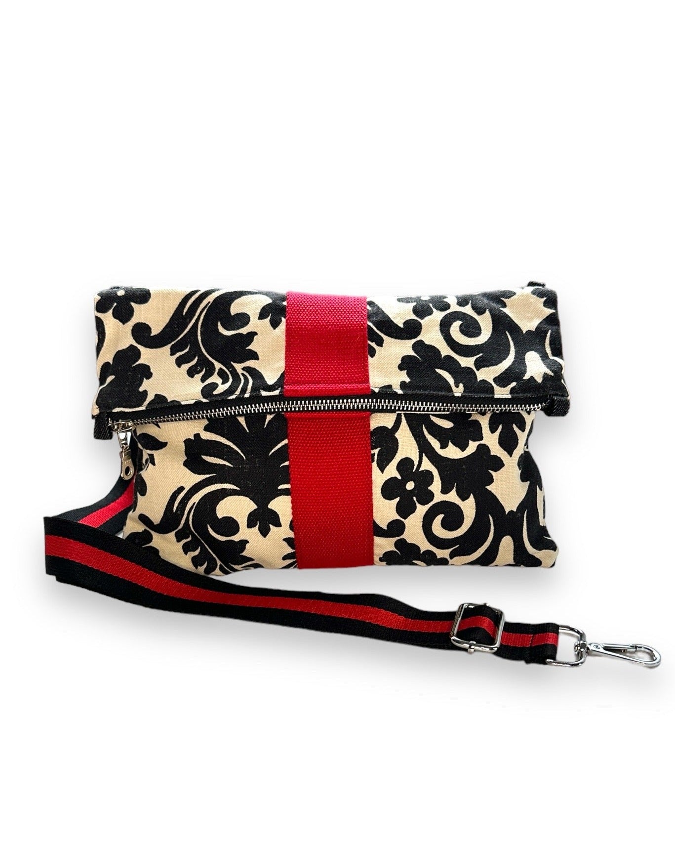 Cream and black foldover clutch with detachable strap. 