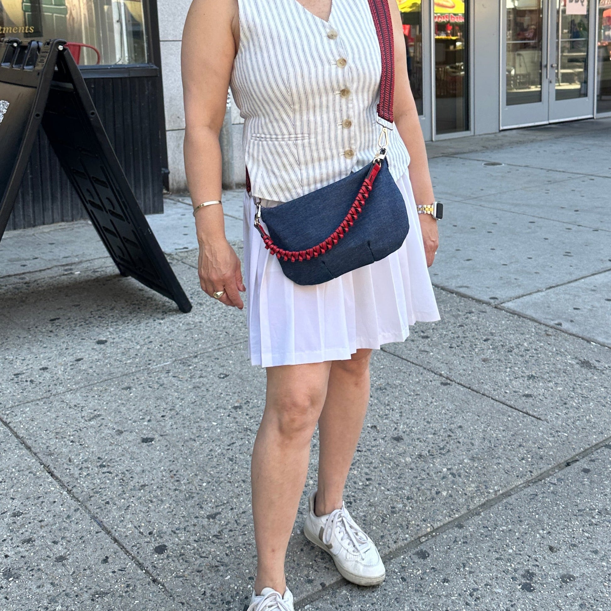 Woman standing on a sidewalk in front of a Shake Shack restaurant