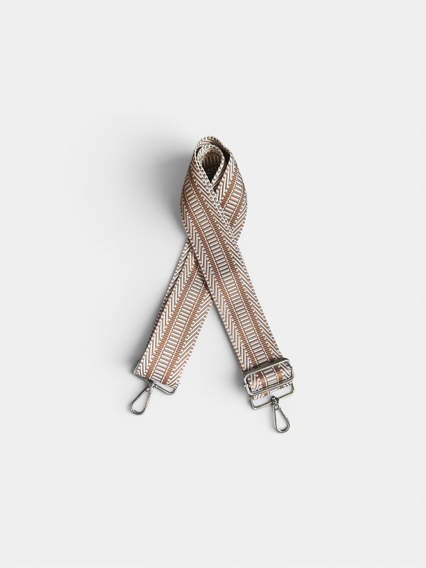 Striped bag strap on a light gray background