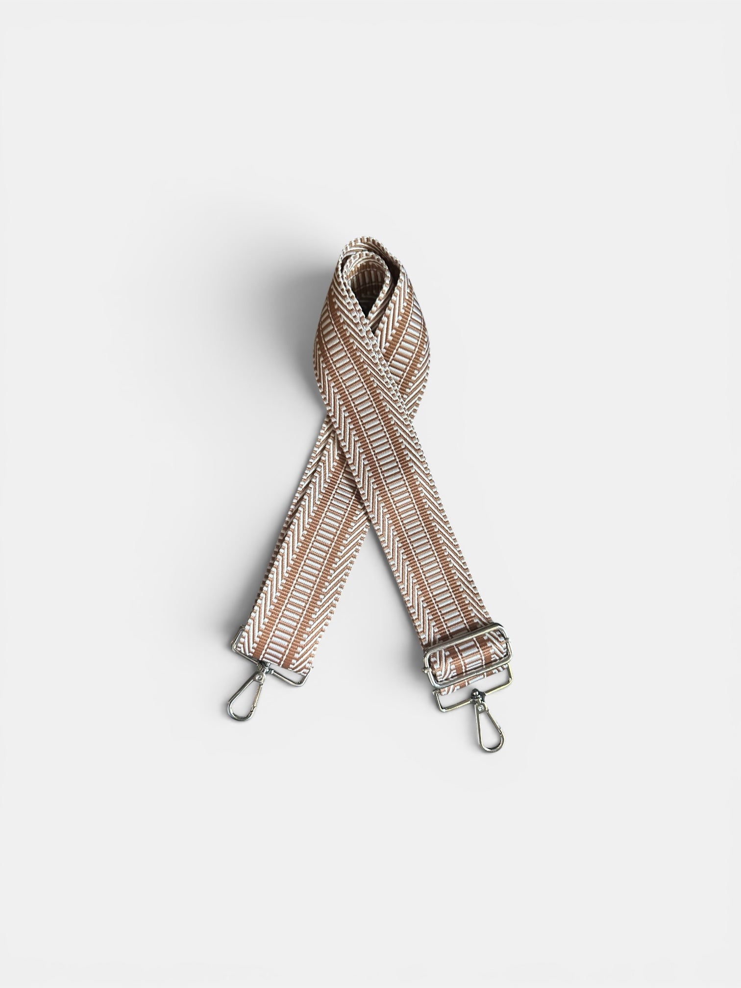 Striped bag strap on a light gray background