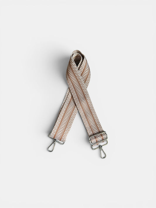 Striped bag strap on a light gray background