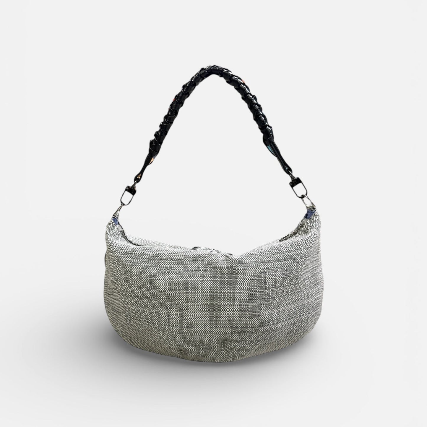 Textured handbag with a black handle on a white background