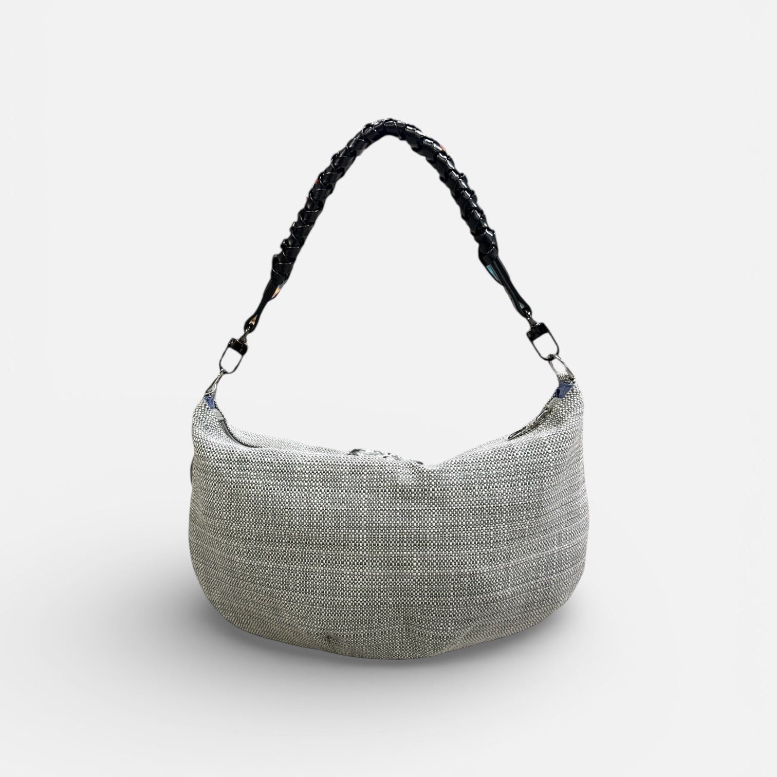 Textured handbag with a black handle on a white background