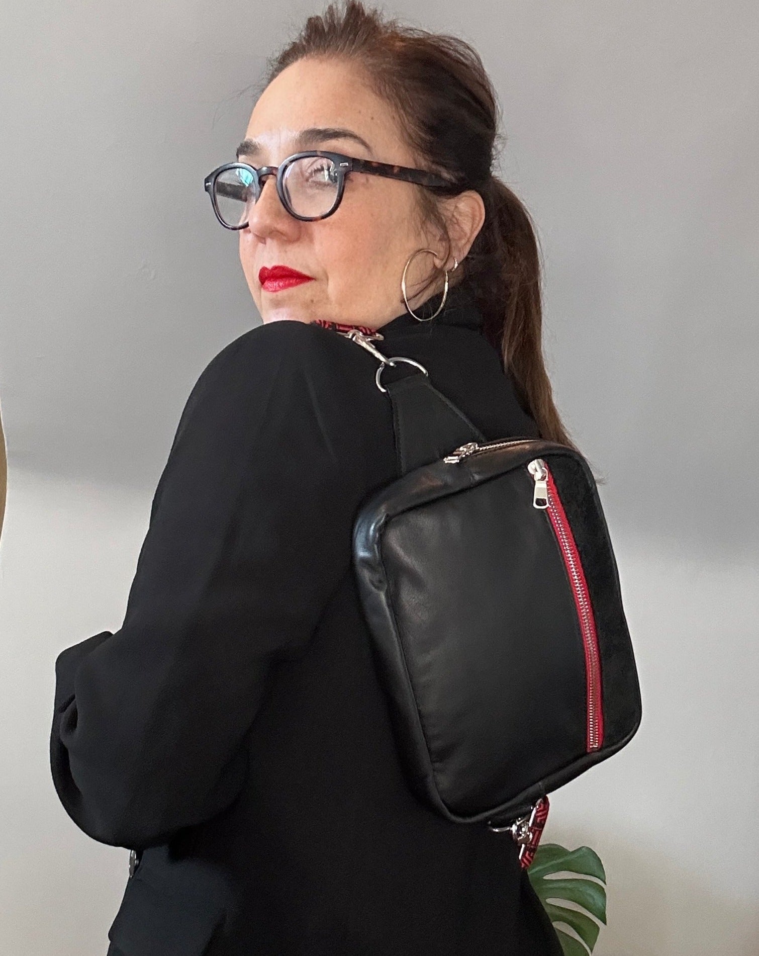 Black leather unisex sling, the ultimate travel bag.