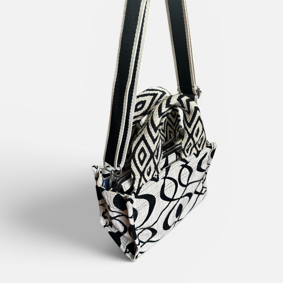 Black and white patterned handbag on a light gray background