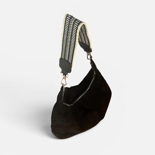 Large black suede slouchy shoulder bag featuring a handwoven Wayuu strap, spacious interior, and artisan craftsmanship for work, travel, and everyday style.