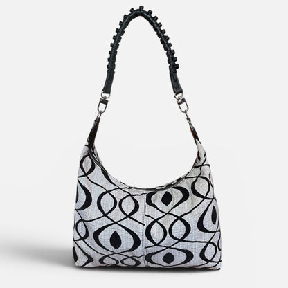 Medium black and cream slouchy shoulder bag featuring a handwoven braided strap, spacious interior, and artisan craftsmanship for everyday style.