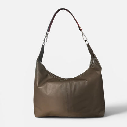 Medium taupe leather slouchy shoulder bag featuring a contrasting red leather shoulder strap, soft silhouette, and spacious interior for everyday wear.